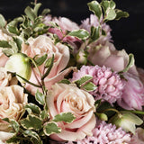 Detail of pink hyacinth, pink mondial roses, pink ranunculus, helleborus and green accents.